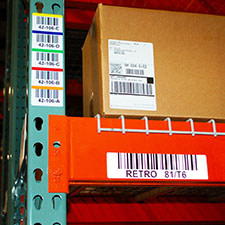 Warehouse location rack labels readable from long distance by using correct barcode X dimension and label material to improve barcode scanning.